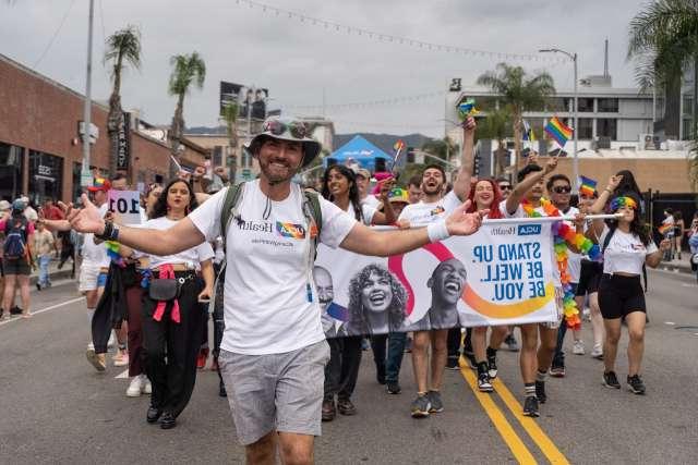 Daniel Kasprowicz leads 皇冠hga025大学洛杉矶分校健康 staff walking in the 53rd annual LA Pride Parade on Sunday