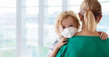 Mom carry son with mask on